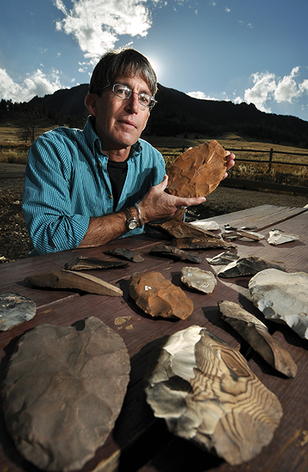 Douglas Bamforth, Anthropology professor for the University of Colorado at Boulder shows a portion of more than 80 artfiacts unearthed about two feet below Boulder resident Patrick Mahaffy's front yard during a landscaping project this past summer. The artifacts, which may have been made during the Clovis period nearly 13,000 years ago, were neatly arranged in a cache near where this portrait was taken, suggesting that the users of these instruments may have intended to reuse them. (Photo by Glenn J. Asakawa/University of Colorado)